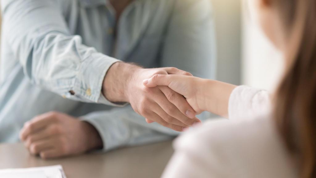 A pro bono attorney shakes hands with a client. 