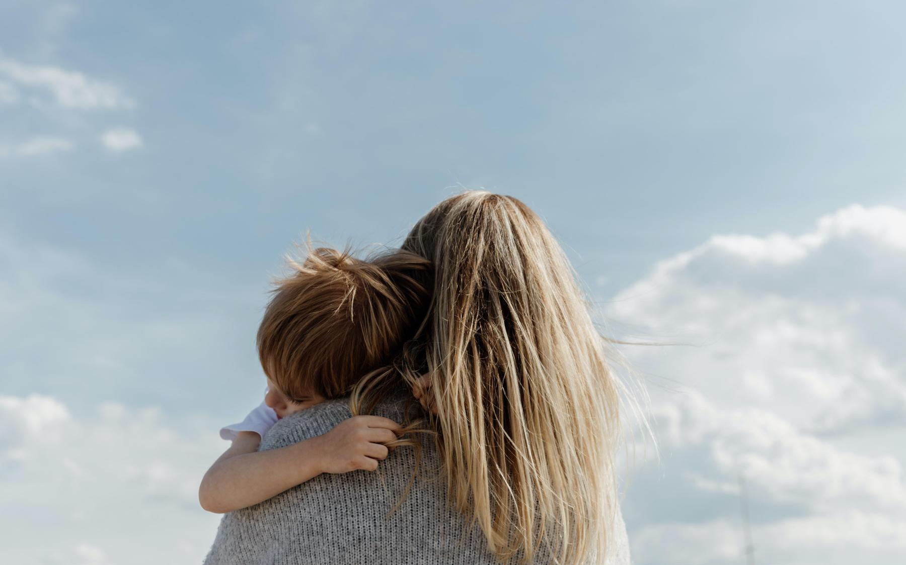 Non-monied spouse holds her child. Divorce when you have no assets. Divorce when your spouse controls all the money. 